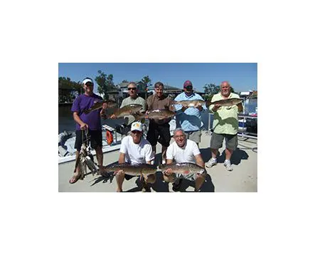 A group of men standing on top of a boat.