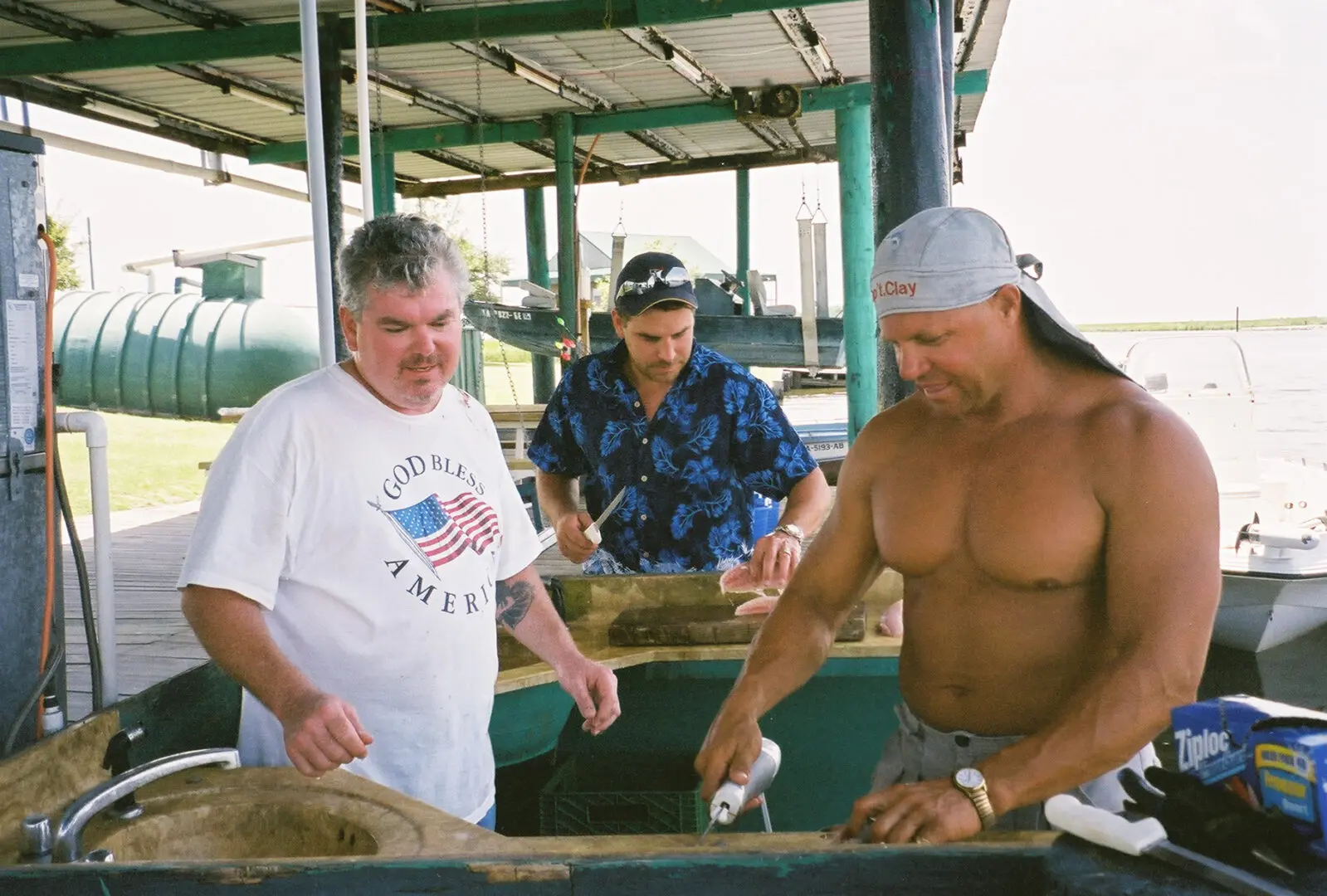 Three men are cooking on a grill.