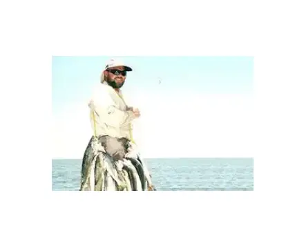 A man standing on top of a surfboard in the ocean.