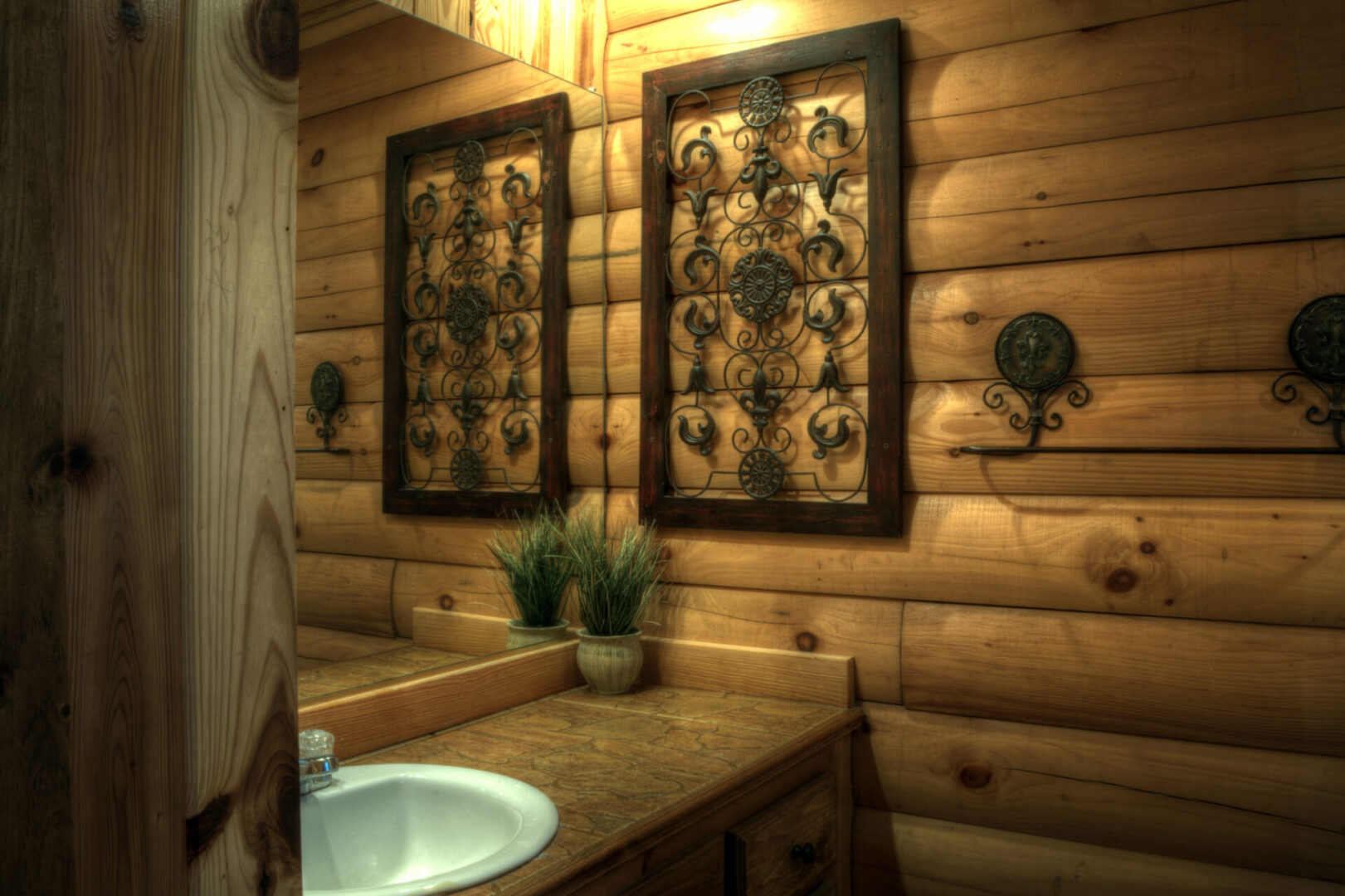 A bathroom with wood paneling and a sink.